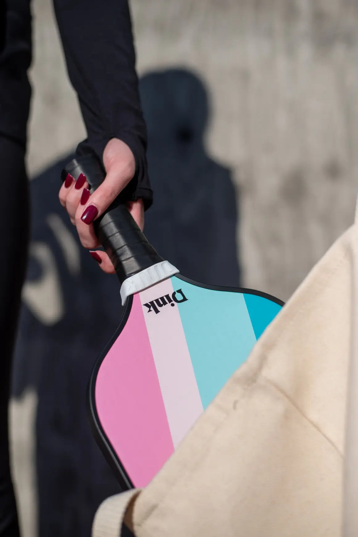 Pickleball player holding a Dink custom pickleball paddle