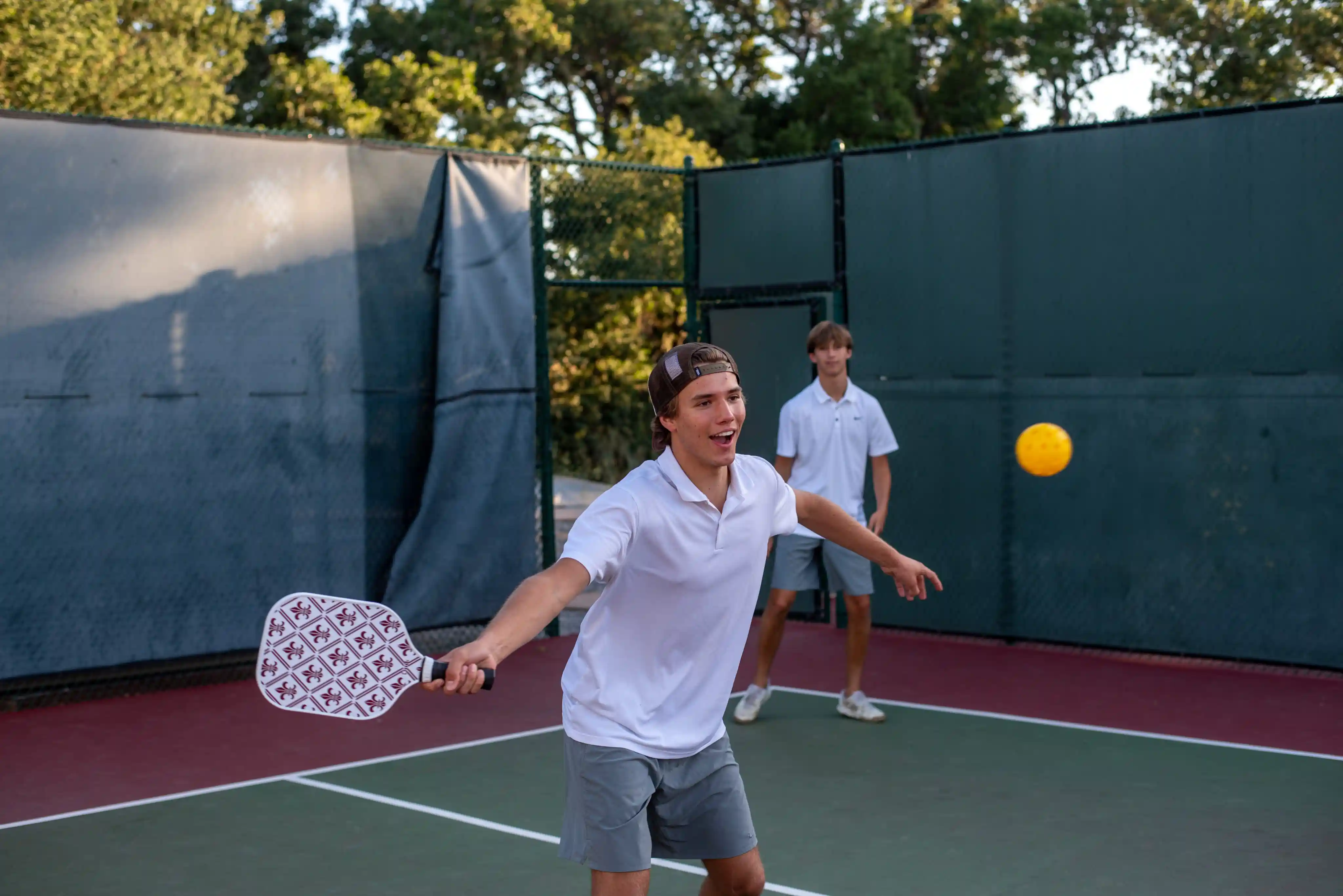 Two young men playing pickleball